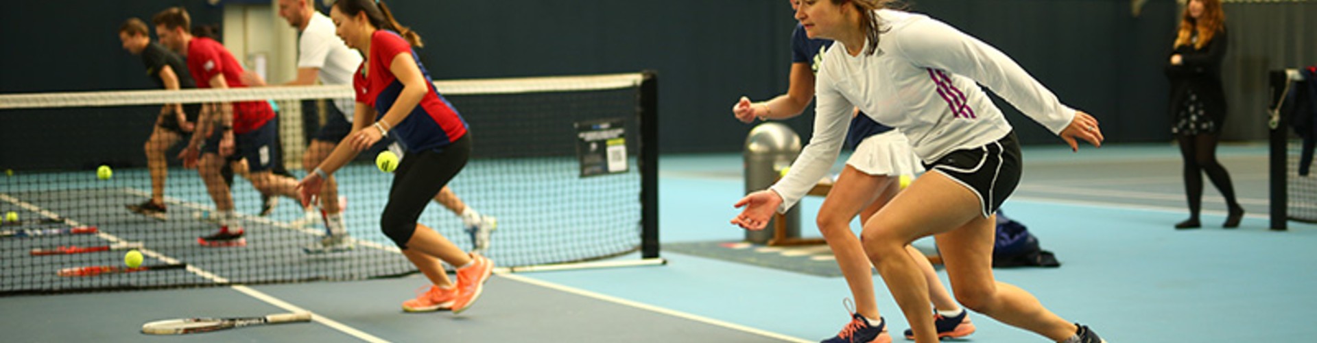 People running towards Tennis rackets and Tennis balls